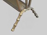 a metal table with a glass top on a gray background