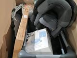 a cardboard box with a baby car seat inside of it