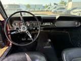 a dashboard and steering wheel of a car in a parking lot