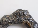 a metal object with a dog on it on a white surface