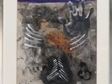 painting of two hands and a tree in a frame on a wall
