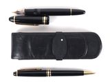 two pens and a pen case sitting next to each other on a white surface