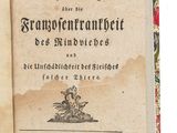 un vieux livre ouvert sur une surface blanche