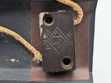 a small piece of leather with a rope on top of it