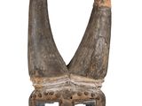 an image of a wooden mask with horns on a white background
