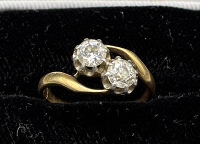 an image of a gold and diamond ring on a velvet surface