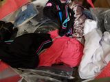 a suitcase full of clothes that is sitting on the floor