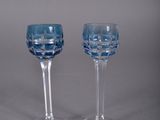 pair of blue glass goblets sitting on top of a table