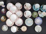 many different types of tea cups and saucers on the table