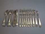 a lot of forks and spoons that are on the table