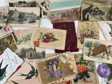 a pile of assorted cards and postcards on a table