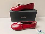 the red shoes are sitting on top of a black box