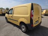 the yellow van is parked in a parking lot with other vans in the background