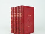 three red books sitting on top of each other on a white surface