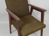 an image of a brown chair with a wooden frame and arm rest