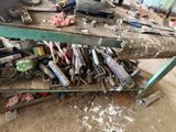 a pile of tools sitting on a workbench in a garage