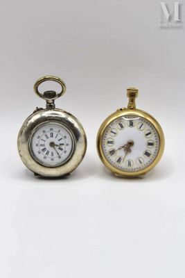 two clocks that are sitting next to each other on a table