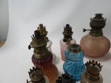 a lot of different colored glass vases on the table