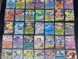 a table topped with lots of different types of pokemon cards