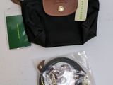 a black purse with a brown handle and a black bag with a brown handle and a black bag with a brown handle and a black bag with a brown