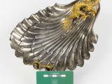 a silver shell with a gold dragon on it