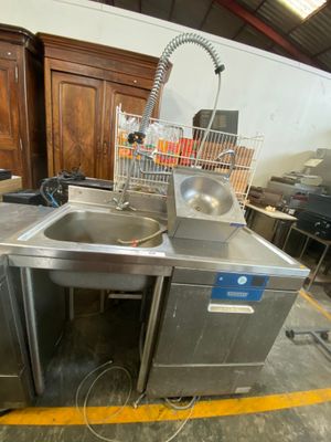 a sink and a dishwasher sitting in a room