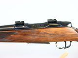 a close up of a rifle on a white background with a white background