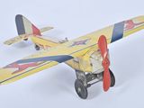 a toy airplane that is sitting on a white surface