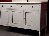 a white cabinet with two pictures on top of it