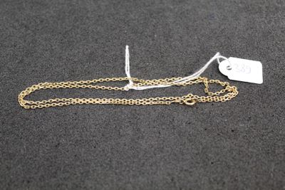 a close up of a gold chain with a tag on it