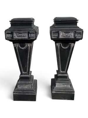 pair of antique black marble pedestals on white background