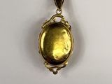 a close up of a gold locke on a white surface
