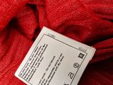 the label on a red fabric is attached to a red cloth
