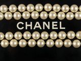 chanel logo with pearls on a black background