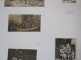 many pictures on the wall of a room with pictures on it
