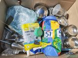 a cardboard box filled with many different types of kitchen utensils