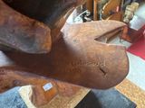 a statue of a dog that is made of wood