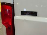 a close up of a sticker on the back of a white truck