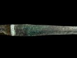 a close up of a knife on a black background