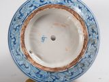 a blue and white plate with a gold rim