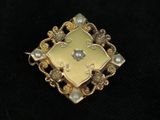 an image of a close up of a broochle on a black surface