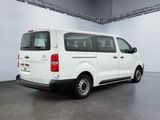the rear end of a white van parked in a garage