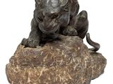 statue of a lion on a rock on a white background