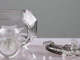 a glass bowl and a glass ashtray sitting on a table