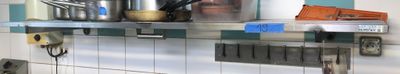 de nombreuses casseroles et poêles sur l'étagère de la cuisine