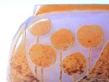 a glass vase with a picture of trees on it