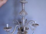 a woman that is holding a chandelier in her hand
