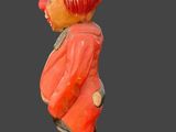 a small statue of a man with a hat on his head