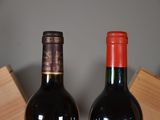 two bottles of wine sitting next to each other on a table
