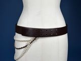 a white mannequin torso with a brown belt and chain around it